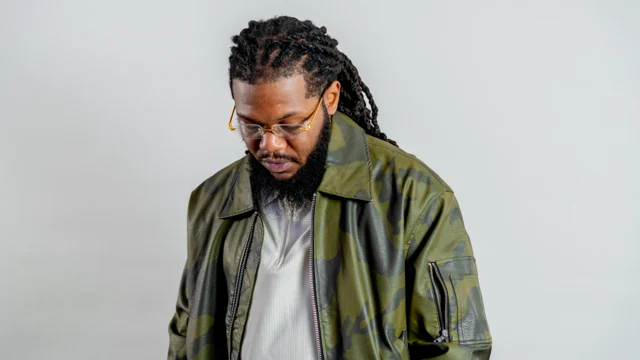 Close studio portrait in a green bomber jacket