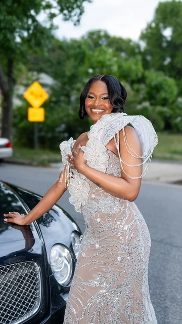 Jaidyn smiling in a shimmering formal gown beside a car