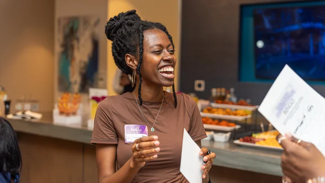 Guest laughing during a conversation at a social gathering